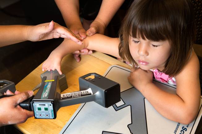 Hailey Dawson closes her eyes as a laser scanner is used to make a 3D model of her deformed hand June 19, 2014 at the University of Nevada, Las Vegas. 