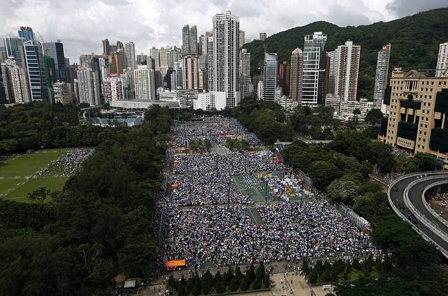 In this July 1, 2014 photo, tens of thousands of residents gather to march in downtown streets during an annual pro-democracy protest in Hong Kong to push for greater democracy. Many in this prosperous city had already feared that Hong Kong’s future as an open society as well as a semiautonomous part of China was in jeopardy in the face of perceived growing intervention from Beijing. 