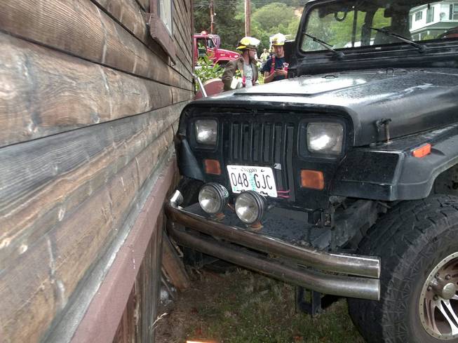 This photo provided by the Myrtle Creek Police Department shows a Jeep that authorities say a toddler crashed into a home in Myrtle Creek, Ore. 