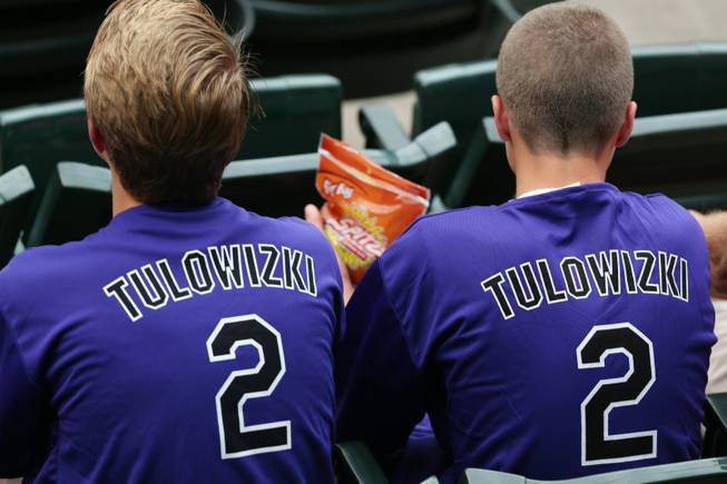 Fans wear shirts with the misspelled surname of Colorado Rockies All-Star shortstop Troy Tulowitzki that were given away to attendees as the Rockies hosted the Pittsburgh Pirates in a baseball game in Denver on Saturday, July 26, 2014.