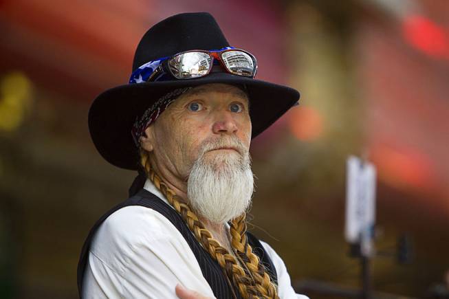 Willie Nelson look-alike Clayton Knutson waits at the Fremont Street Experience Sunday, July 27, 2014.