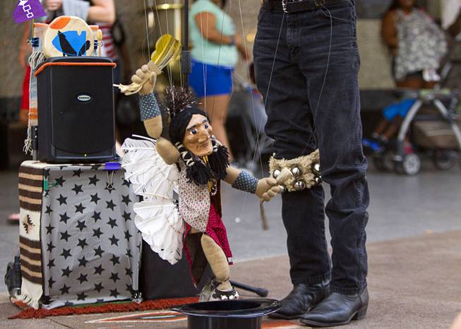 A marionette is brought to life by Buddy Big Mountain at the Fremont Street Experience Sunday, July 27, 2014.