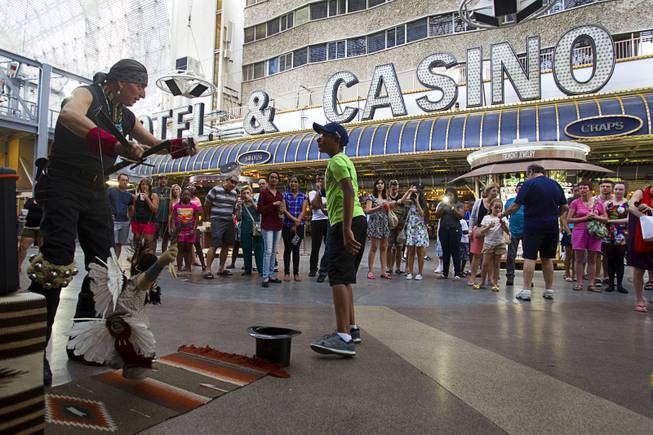 Buddy Big Mountain operates a marionette at the Fremont Street Experience Sunday, July 27, 2014.