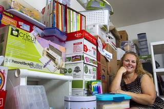 Kindergarten teacher Christine Cordova sits among school supplies stacked against a wall in the garage of her home in Henderson Sunday, July 27, 2014. Cordova rented a 19-foot U-Haul to pack up her classroom supplies from her old school as she prepares to move into a new school in the fall.