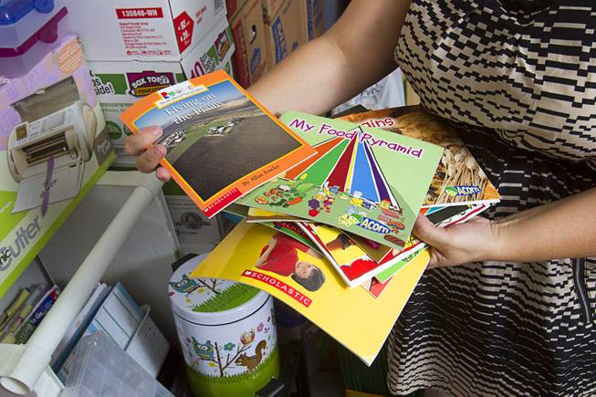 Books purchased by kindergarten teacher Christine Cordova are displayed in the garage of her home in Henderson Sunday, July 27, 2014. Cordova rented a 19-foot U-Haul to pack up her classroom supplies from her old school as she prepares to move into a new school in the fall.