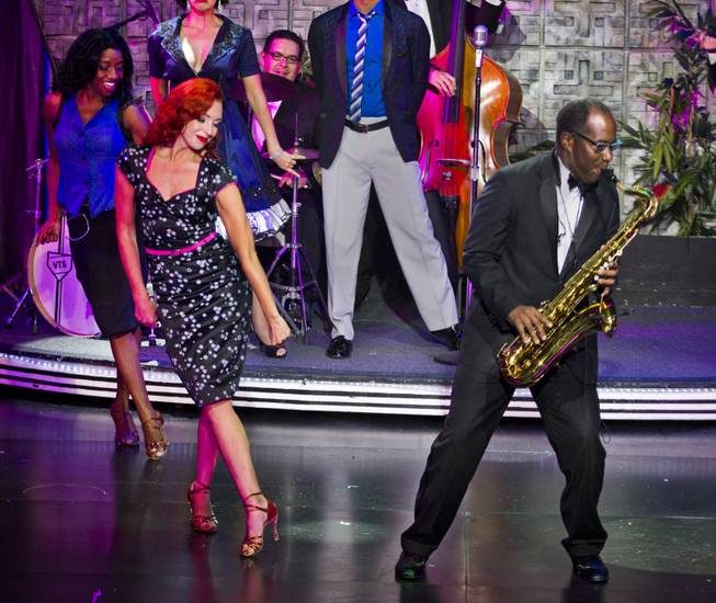 Principal dancer Tara Palsha performs with sax player Philip Wigfall and cast during her final night in "Vegas! The Show' on Friday, July 25, 2014.