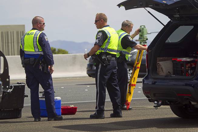 Nevada Highway Patrol troopers take measurements after a fatal rollover on Highway 95 southbound at Jones Boulevard Monday, July 28, 2014. A 48-year-old man was ejected from the vehicle and died at the hospital.