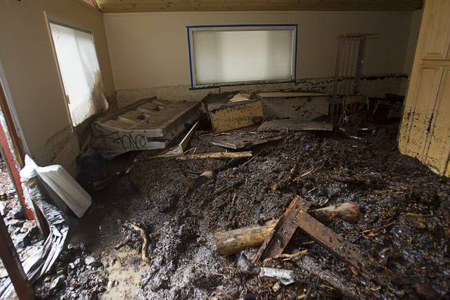 Debris is shown inside a home in the Rainbow Subdivision on Mt. Charleston Monday, July 28, 2014. The homeowners were still repairing the home from last year's storm, neighbors said.