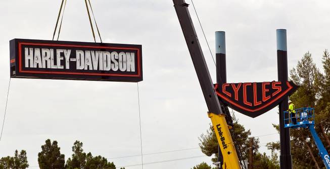 Workers with the Ad Art Sign Company mount the three-piece sign outside the new Las Vegas Harley-Davidson Motorcycle dealership on the South Strip now under construction Thursday, July 10, 2014. 