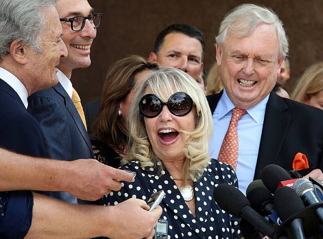 With her attorney Pierce O'Donnell, right, Shelly Sterling, center, talks to reporters after a judge ruled in her favor and against her estranged husband, Los Angeles Clippers owner Donald Sterling, in his attempt to block the $2 billion sale of the NBA basketball team, outside Los Angeles Superior Court, Monday, July 28, 2014. 
