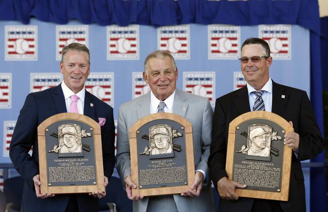 National Baseball Hall of Fame inductees Tom Glavine, Bobby Cox and Greg Maddux hold their plaques after an induction ceremony at Clark Sports Center on Sunday, July 27, 2014, in Cooperstown, N.Y.