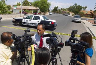 Metro Police public information officer Jose Hernandez speaks to Spanish-language reporters in a neighborhood near Tropicana Avenue and Sandhill Road after an officer-involved shooting Tuesday, July 29, 2014.