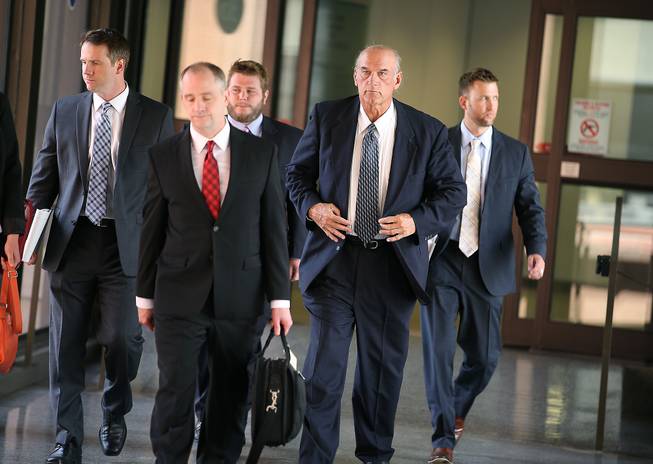 Former Minnesota Gov. Jesse Ventura, second from right, makes his way out of the Warren E. Burger Federal Building during the first day of jury selection in a defamation lawsuit Tuesday, July 8, 2014, in St. Paul, Minn. Ventura filed the defamation lawsuit against the Chris Kyle estate claiming that Kyle's account of a bar fight in a book he wrote was false.