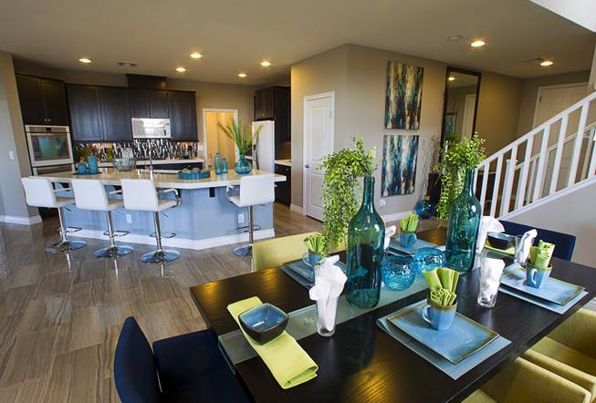 A dining area and kitchen are shown in a two-story plan 2568 model home at KB Homes' Tevare residential development in Summerlin Wednesday, July 30, 2014.