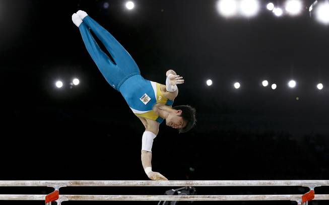 Naoya Tsukahara of Australia performs on the parallel bars during the Men's All-Around gymnastics competition at the Scottish Exhibition Conference Centre during the Commonwealth Games 2014 in Glasgow, Scotland, Wednesday July 30, 2014. 