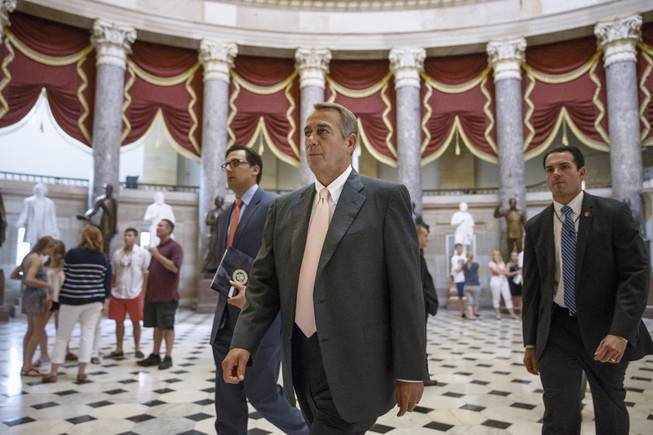 House Speaker John Boehner of Ohio strides to the House chamber on Capitol Hill in Washington, Wednesday, July 30, 2014, as lawmakers prepared to move on legislation authorizing an election-year lawsuit against President Barack Obama that accuses him of exceeding his powers in enforcing his health care law.