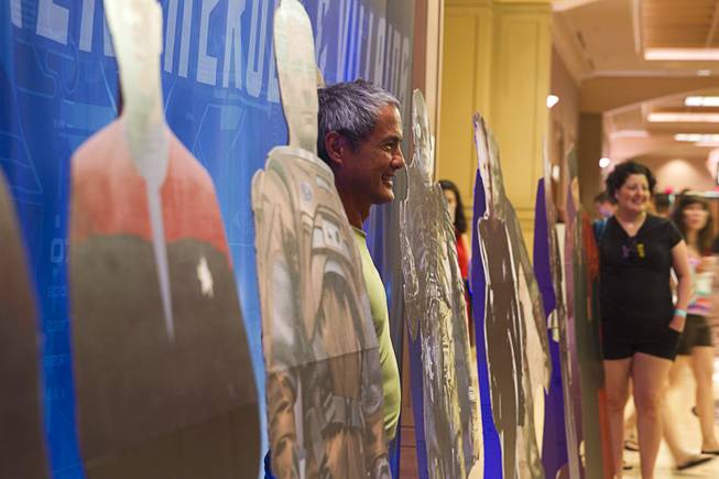Nick Kishmirian of Sebastopol, Calif. poses among cardboard cutouts of Star Trek characters during the 13th annual Official Star Trek Convention at the Rio Thursday, July 31, 2014. The convention, expected to attract 15,000 Trekkies, runs through Sunday.