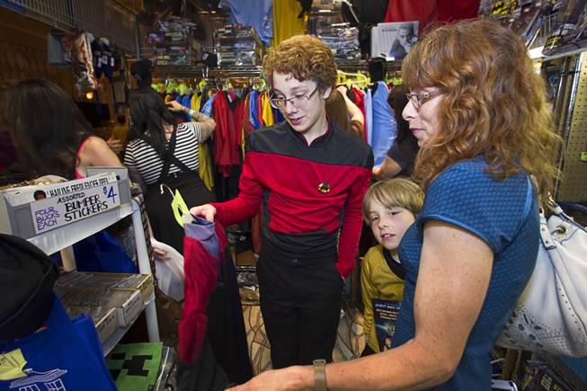 Cyrus Bickell, 13, of Evergreen, Colo. shops for uniforms with his brother Cole,9, and his mother Valerie during the 13th annual Official Star Trek Convention at the Rio Thursday, July 31, 2014. Bickell said he has watched every Star Trek episode in chronological order.