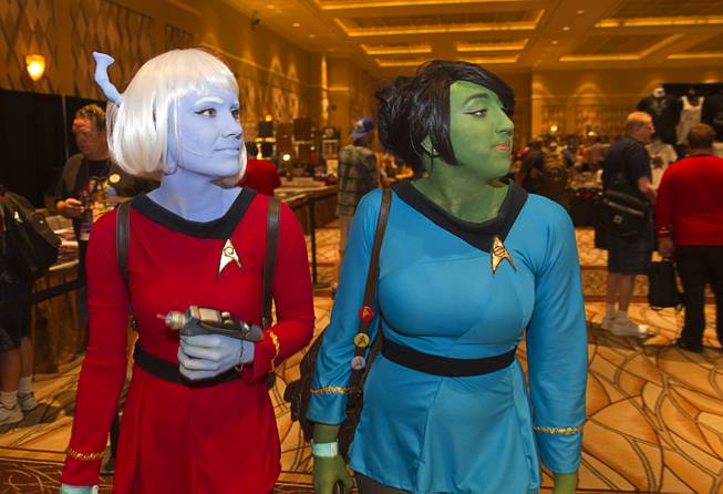 Stephanie Rowe, left, dressed as an Andorian, and Victoria Blake, as an Orion, both of Phoenix, look over a vendors area during the 13th annual Official Star Trek Convention at the Rio Thursday, July 31, 2014. The convention, expected to attract 15,000 Trekkies, runs through Sunday.
