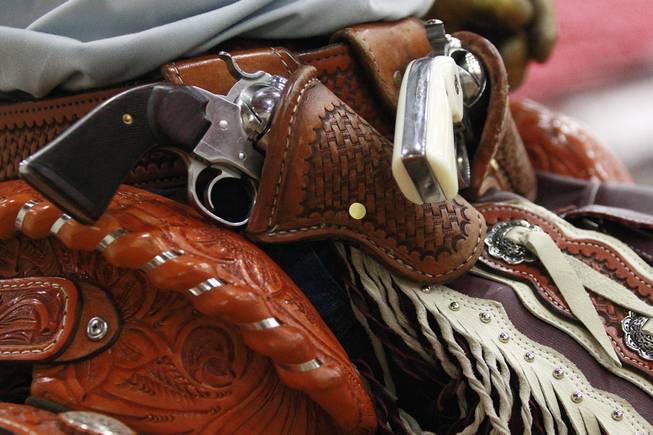 A cowboy's revolvers are seen in their holster during the Cowboy Mounted Shooting Association's Western U.S. ChampionshipThursday, July 31, 2014 at the South Point.
