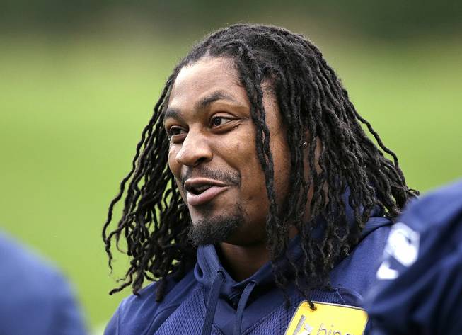 In this June 17, 2014, file photo, Seattle Seahawks' Marshawn Lynch smiles at a football minicamp practice that he watched from the sidelines in Renton, Wash. 