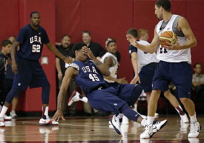 Toronto Raptors' DeMar DeRozan falls to the floor while holding his face after he was hit by Golden State Warriors' Klay Thompson during a USA Basketball minicamp scrimmage Monday, July 28, 2014, in Las Vegas. 