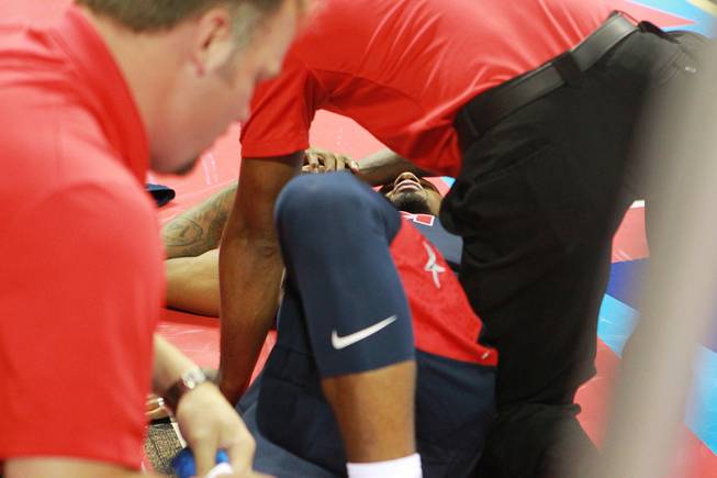 Paul George is attended to after fracturing his leg during the 2014 USA Basketball Showcase Friday, Aug. 1, 2014 at the Thomas & Mack Center.