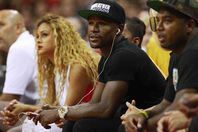 Junior middleweight champion Floyd Mayweather watches the action during the 2014 USA Basketball Showcase Friday, Aug. 1, 2014 at the Thomas & Mack Center.