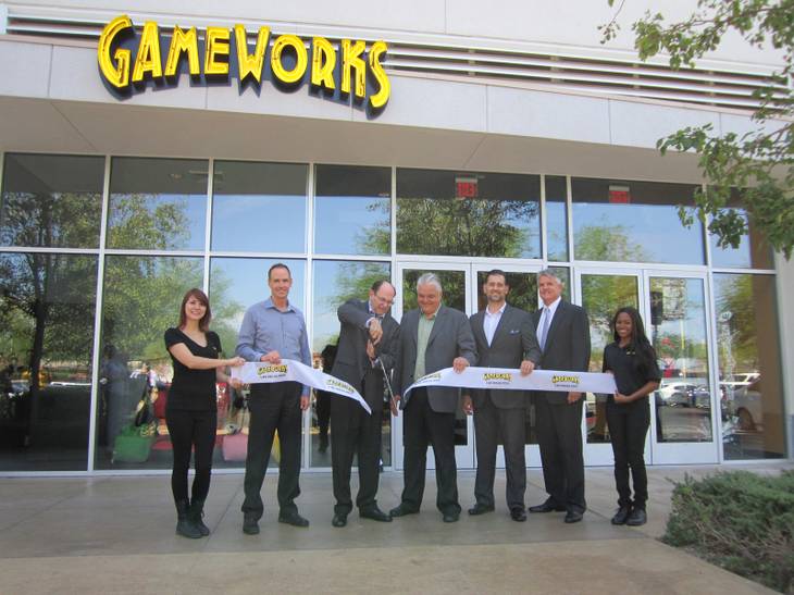 GameWorks’ Chairman of the Board Howard Brand cuts the ceremonial ribbon at the grand opening of the new location as Town Square, GameWorks and city representatives look on.