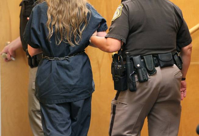 One of the two Wisconsin girls accused of stabbing a classmate is led out of a courtroom, Wednesday, July 2, 2014. Doctors have found that one of the two 12-year-old Wisconsin girls accused of stabbing a classmate to please a fictional online horror character is mentally incompetent to stand trial, attorneys said.