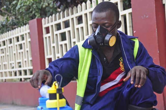 An employee of the Monrovia City Corp. mixes disinfectant before spraying it on the streets in a bid to prevent the spread of the deadly Ebola virus in the city of Monrovia, Liberia, Friday, Aug. 1, 2014.