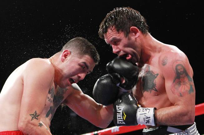 Diego Chaves gets hit with a left from Brandon Rios during their welterweight fight Saturday, Aug. 2, 2014 at the Cosmopolitan. Rios won after Chaves was disqualified in the ninth round.