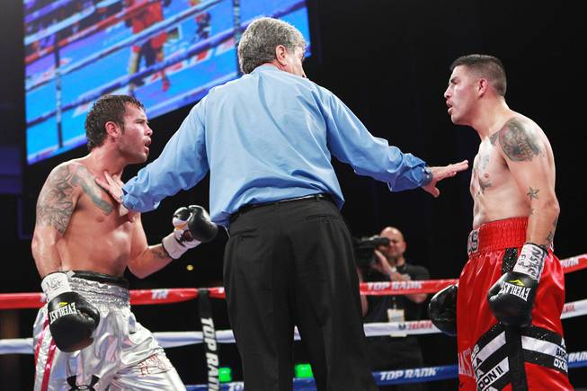 Referee Vic Drakulich separates Diego Chaves and Brandon Rios during their welterweight fight Saturday, Aug. 2, 2014 at the Cosmopolitan. Rios won after Chaves was disqualified in the ninth round.
