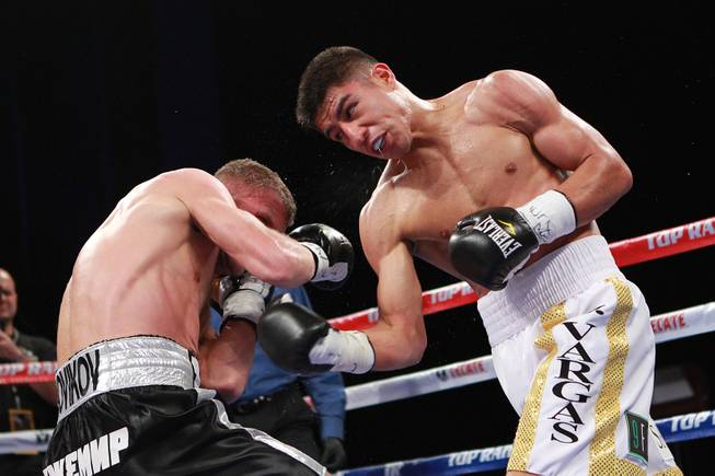 Jessie Vargas hits Anton Novikov with a right during their WBA light welterweight title fight Saturday, Aug. 2, 2014 at the Cosmopolitan. Vargas won by decision.
