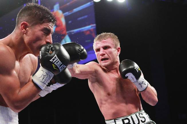Jessie Vargas is hit by a right from Anton Novikov during their WBA light welterweight title fight Saturday, Aug. 2, 2014 at the Cosmopolitan. Vargas won by decision.