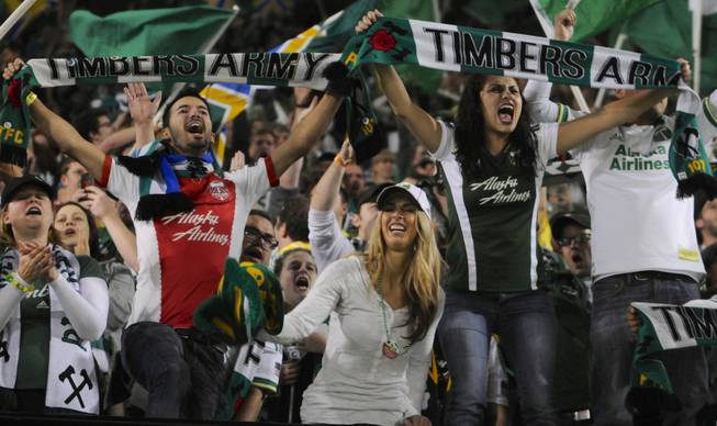 Portland Timbers fans celebrate a 1-0 win against Seattle in an MLS game in Portland, Ore., on Sunday, Oct. 13, 2013. 