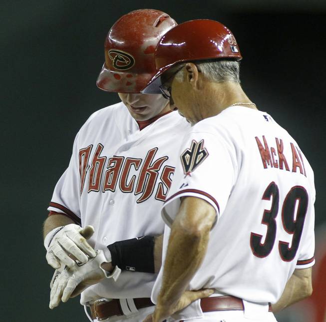 Arizona Diamondbacks' Paul Goldschmidt, left, shows first base coach Dave McKay where he was hit by a pitch during the ninth inning of a baseball game against the Pittsburgh Pirates on Friday, Aug. 1, 2014, in Phoenix. The Pirates defeated the Diamondbacks 9-4.