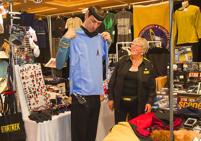 Paul "Spock Vegas" Forest shops for clothes as Angela Ketsten looks on during the final day of the 13th annual Official Star Trek Convention at the Rio Sunday, Aug. 3, 2014.