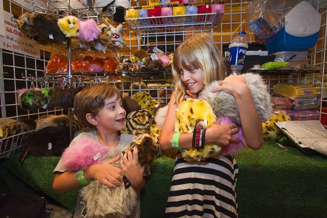 Nathan Yates, 5, and Linzy McGuire, 9, pose with tribbles at the Tribbble Toy booth during the final day of the 13th annual Official Star Trek Convention at the Rio Sunday, Aug. 3, 2014. Tribbles first appeared in a Star trek episode titled "The Trouble with Tribbles" (original series) and are one of the well-known species featured in the Star Trek universe.