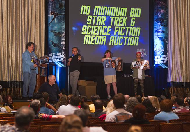 Star Trek collectables are auctioned during the final day of the 13th annual Official Star Trek Convention at the Rio Sunday, Aug. 3, 2014.