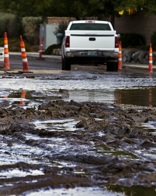 Heavy rains have caused serious flooding and piles of mud to collect along West Grand Teton Drive at the intersection of North Tenaya Way on Monday, August 4, 2014.