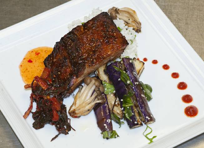 Lemongrass pork sparerib with grilled sesame is pictured, served with Japanese eggplant, cilantro sticky rice, roasted mushrooms and kimchi dish prepared by Chef Rob at Cafe DiVine inside the Springs Preserve.