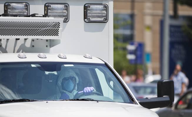 An ambulance transporting Nancy Writebol, an American missionary stricken with Ebola, arrives at Emory University Hospital, Tuesday, Aug. 5, 2014, in Atlanta. 
