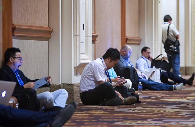 Attendees work in a hallway during the Black Hat USA 2014 hacker conference at the Mandalay Bay Convention Center Aug. 6, 2014.