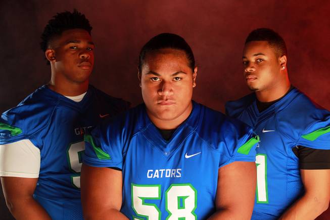 From left, Green Valley High School football  players Cordell Tidwell, Tafe Vete and Larry Norman July 21, 2014.