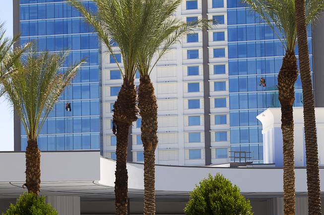 Window washers work at the SLS Las Vegas Thursday, August 7, 2014. The new resort, formerly the Sahara, will open on August 23.