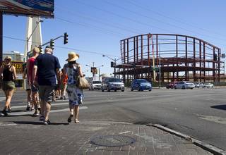 Tourists pass by construction at the northeast corner of Sahara Avenue and Las Vegas Boulevard South on Thursday, Aug. 7, 2014. A Walgreens will occupy about half of the first floor. Wilger Enterprises is the general contractor on the project.