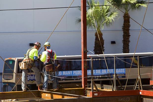 Iron workers are shown during construction of a building at the northeast corner of Sahara Avenue and Las Vegas Boulevard South Thursday, August 7, 2014. A Walgreens will occupy about half of the first floor. Wilger Enterprises is the general contractor on the project.