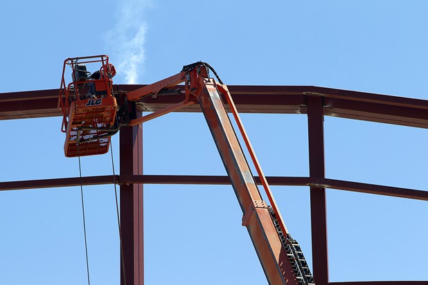 A Valley Steel iron worker welds during construction of a building at the northeast corner of Sahara Avenue and Las Vegas Boulevard South Thursday, August 7, 2014. A Walgreens will occupy about half of the first floor. Wilger Enterprises is the general contractor on the project.