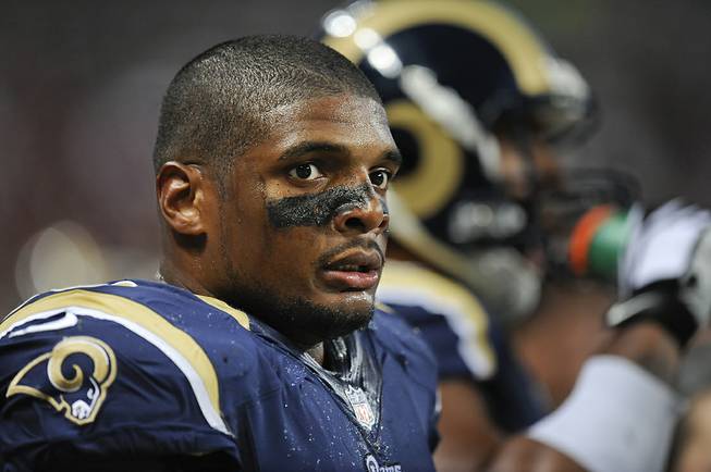 St. Louis Rams defensive end Michael Sam watches from the sideline in the second quarter of a preseason NFL game between the Rams and the New Orleans Saints on Friday, Aug. 8, 2014, in St. Louis. 